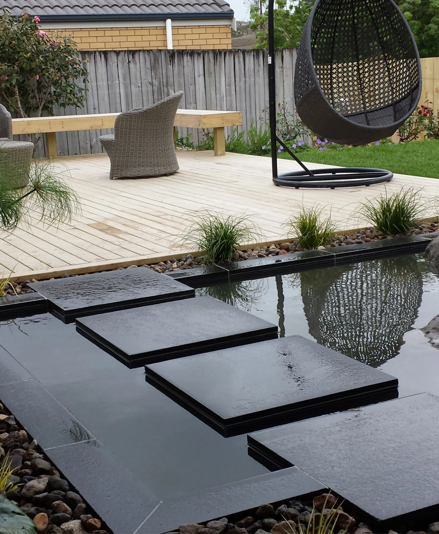 Hard landscaping with paving and water feature by Warwick Price Landscaping Auckland