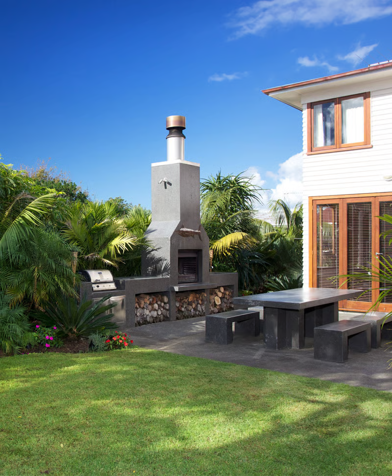 Landscape design with outdoor fireplace and patio area in Auckland