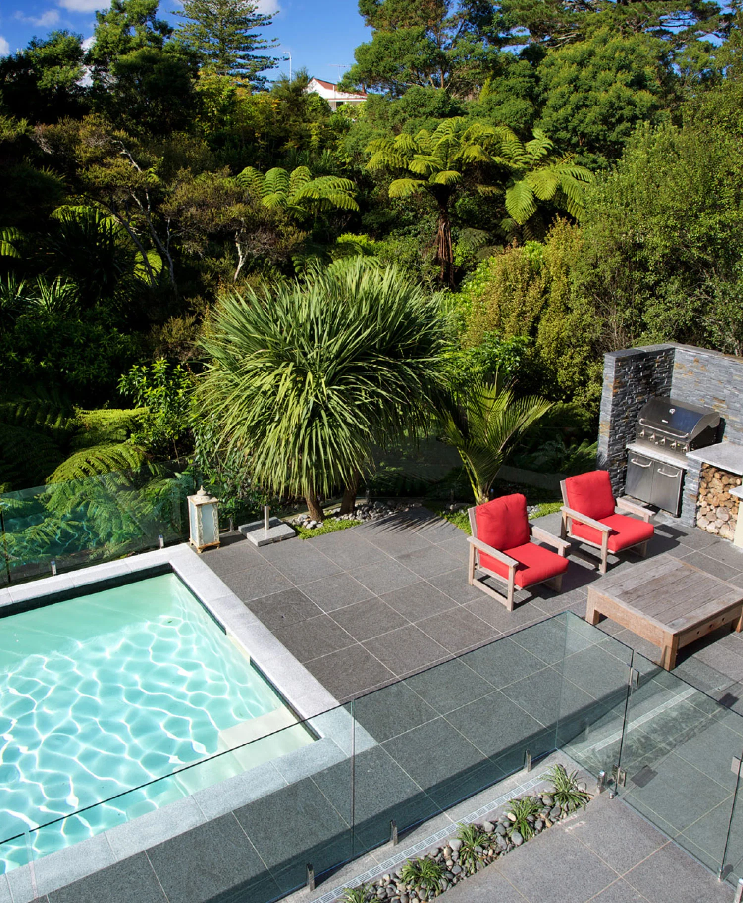 Outdoor living area with timber deck and pool surround in Auckland
